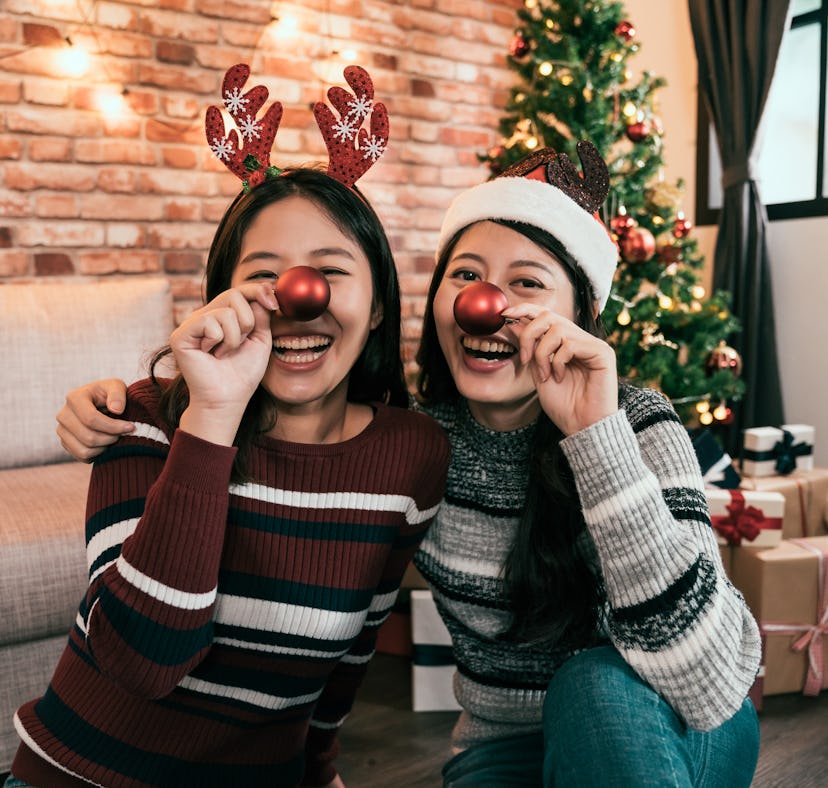 Sisters wearing red noses at Christmas to post on Instagram with reindeer puns and reindeer quotes.