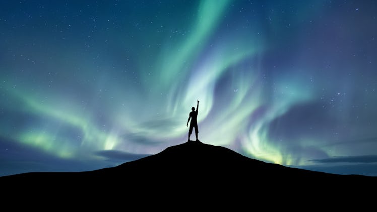 Silhouette of a championat the northen light background. Sport and active life concept and idea of s...