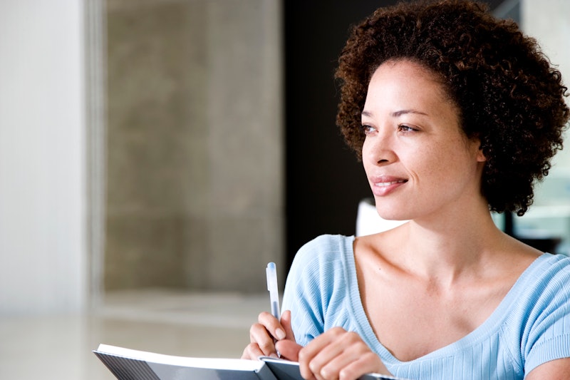 Woman writing a diary or journal at home