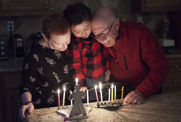 Lighting a menorah is just one Hanukkah tradition to do with your family.
