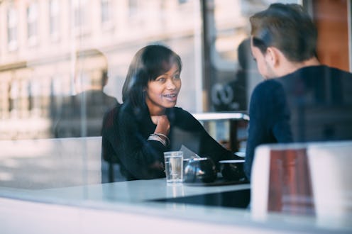 Interracial couple talking in coffee shop