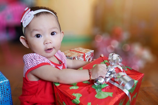 A baby girl with a Christmas gift