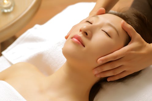 Asian beauty is receiving facial treatment from a beautician