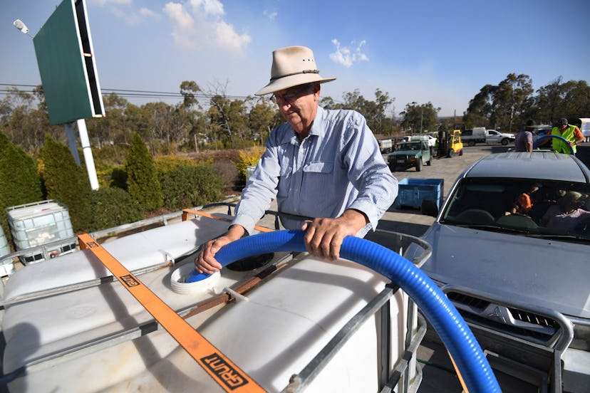 A man collects the water handed out by a local charity group in Stanthorpe, Queensland, Australia, 1...