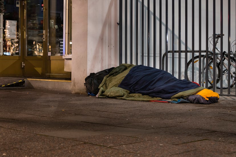 Sleeping Homeless Man, Homeless man in sleeping bag on sidewalk, homelessness in the city