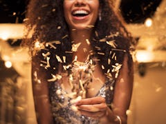 A smiling woman is holding a sparkler outside in a celebratory mood. Here's your february 2022 full ...