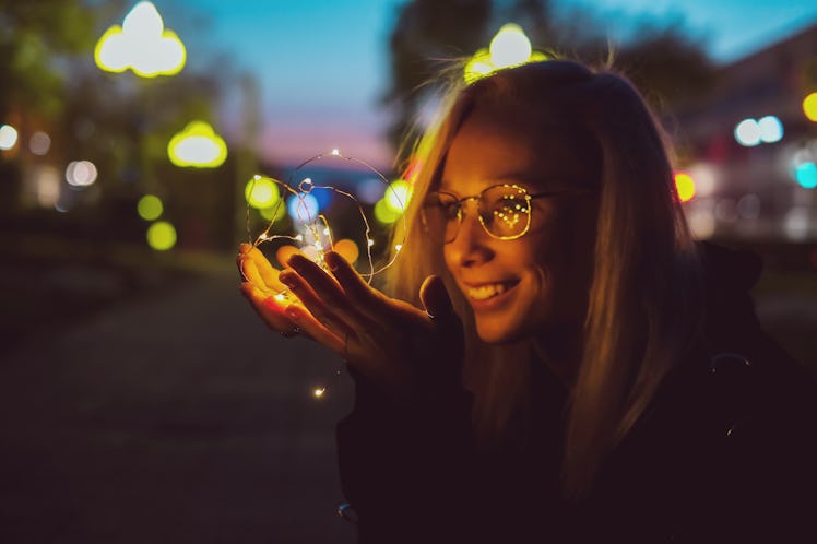 Romantic portrait of a girl with lights on the night street