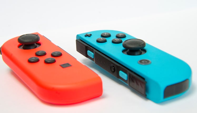 macro photo photography of a wireless console controller in different colors detail in high key