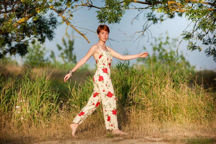 WOMAN WALKING IN THE COUNTRYSIDE