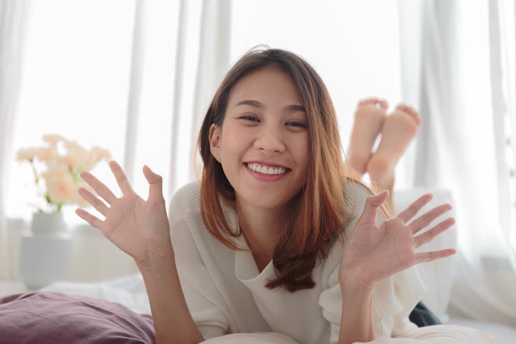 Portrait of beautiful smiling woman in bed at home