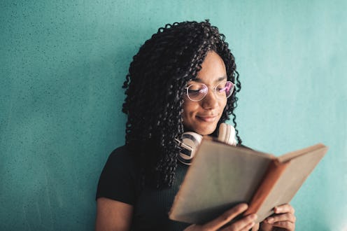 beautiful young woman reads a book