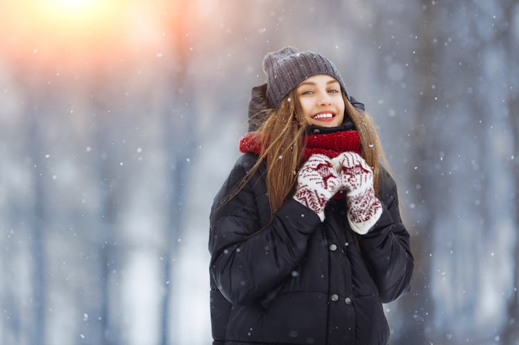 Winter young woman portrait. Beauty Joyful Model Girl laughing and having fun in winter park. Beauti...