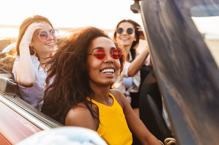 Photo of a beautiful gorgeous smiling cheery young pretty women friends driving the car.