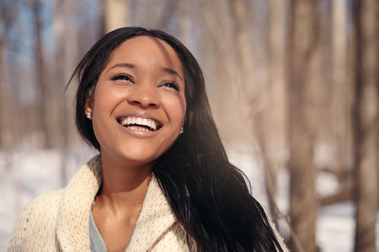 Beautiful young woman in the snow in winter