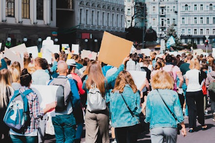 Young people marching on the street protest. Take a part in a march. Rally. Movement. Protest in the...