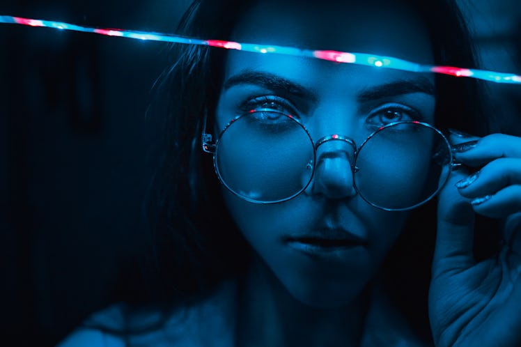 Close-up portrait of a girl with glasses.  Garland neon
