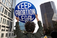 An activist seen holding a placard that says Keep Abortion Legal during the protest.
