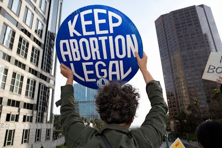 An activist seen holding a placard that says Keep Abortion Legal during the protest.