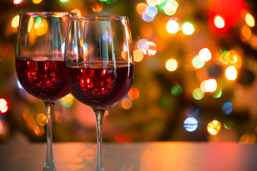 Crystal glasses of wine on the background of Christmas lights