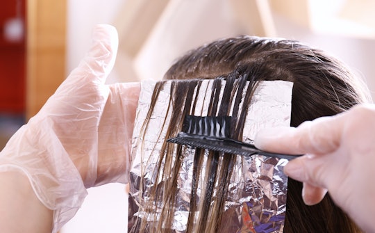 Process of dyeing hair at beauty salon, closeup