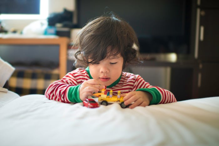 toddler boy playing with toys on Christmas morning