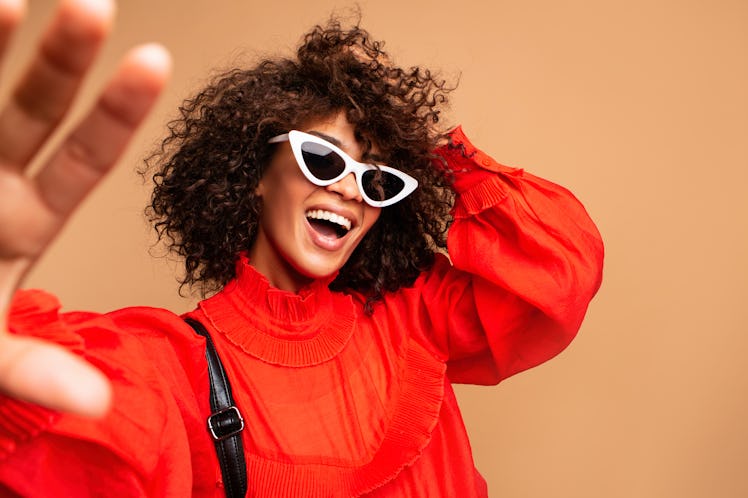 Portrait of beautiful young black woman taking selfie.Portrait of a pretty young afro american woma...