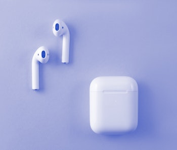 Air Pods. with Wireless Charging Case. New Airpods 2019 on pink background. Airpods. female headphon...