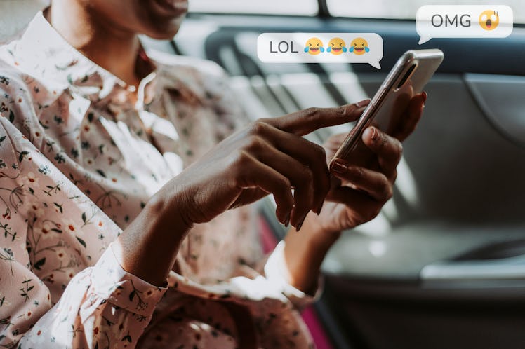 Black woman texting in a car