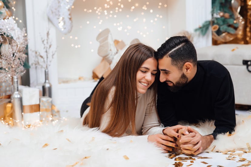 Adding some romance. Holiday romance of bearded man and sexy woman. Couple in love relaxing in the s...