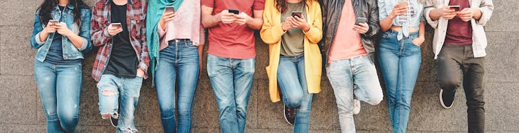 Group of friends using their smart mobile smartphones outdoor - Millennial young people addicted to ...