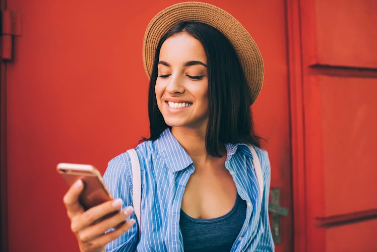 Cheerful Ukrainian woman laughing during online chatting with best friend connecting to 4g wireless ...