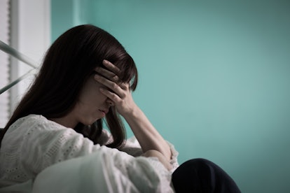 woman feel depression, heartbreak, sitting on a bed, stressed