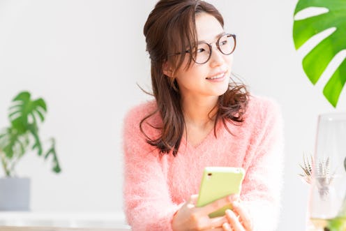 young attractive asian woman to see a smart phone