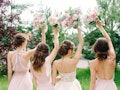 Wedding bouquets. Bridesmaid's bouquets. Bride with bridesmaids in dust pink dresses have fun in wed...