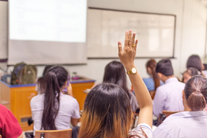 Education concept, student raising hand up in the class to ask questions and answer the topic in the...
