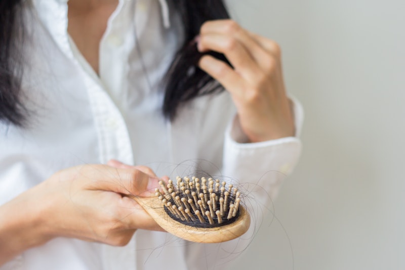 Closeup of comb brush with long loss hair with copy space-Healthcare concept.Selective focus.