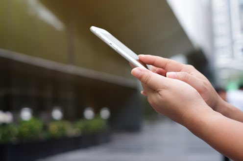 close up woman's hand hold mobile phone device for work play or read or text on gadget for innovatio...