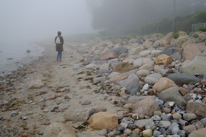 Woman in the fog on the coast