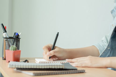 Woman working on office desk. Homework or Freelance work at home. Blogger.