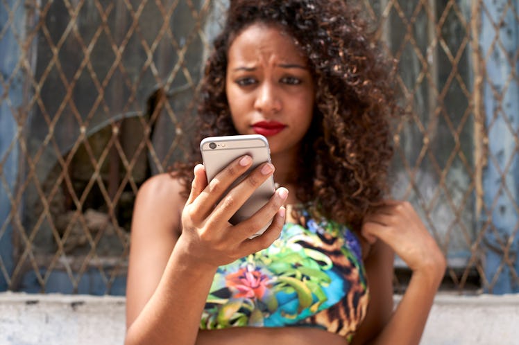 Woman frowning checking her phone