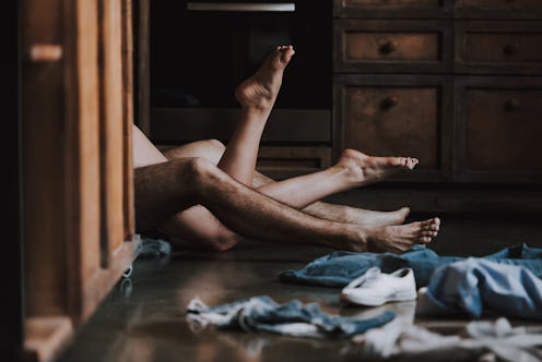 Attractive Passionate Couple Having Sex in Kitchen. Man and Woman Lying on the Floor in the Kitchen ...