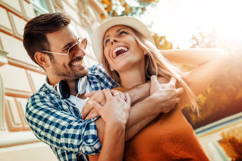 Smiling couple in love outdoors.Young happy couple hugging on the city street.