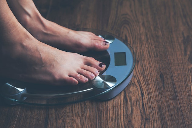 Feet of a young woman in scale