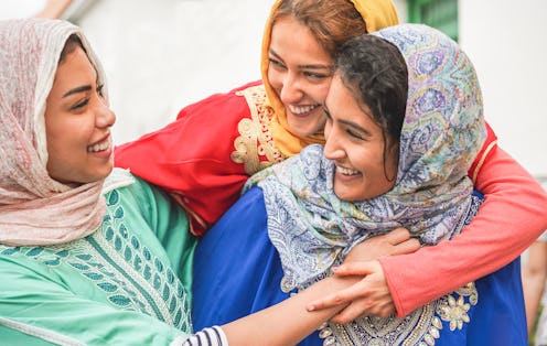Young islamic friends having fun outdoor - Happy arabian friends laughing and smiling together - Fri...