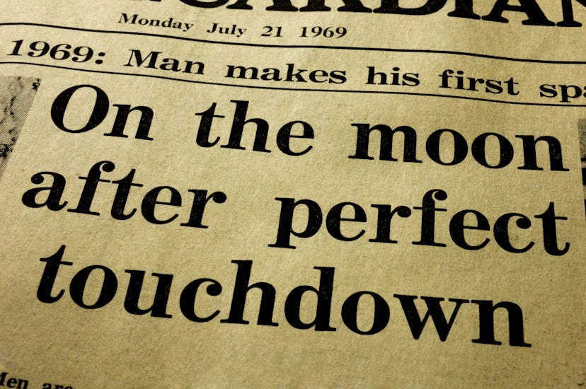 History. Close-up of the headline from a paper, the day after the first man landed on the Moon.