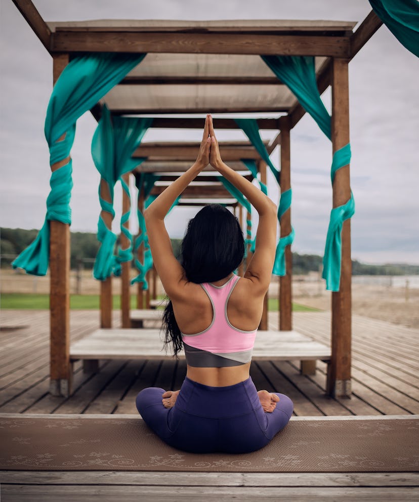 Young woman practicing yoga outdoor 