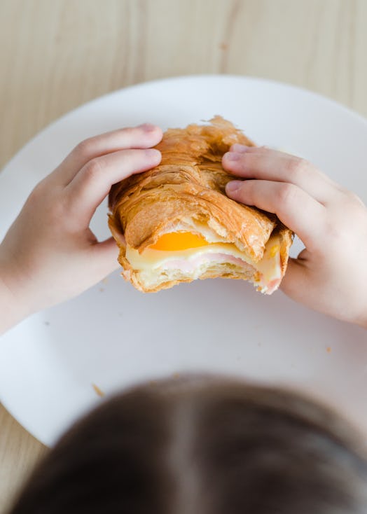 croissant sandwich in kids hands