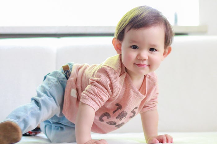 Crawling baby boy smiling at home. Healthy adorable mixed race Asian-German kid wearing red T-shirt ...