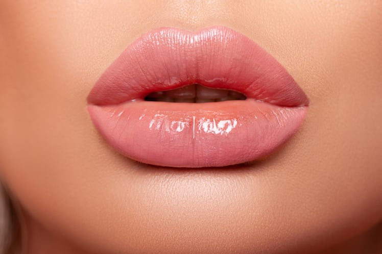 Beautiful curvy feminine lips with nude lipstick. Large Volumetric Lips, mouth open, puffy lips, glo...
