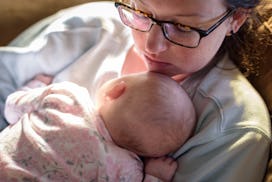 new mom napping with baby in her arms